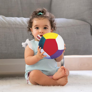 Funskool Giggles Soft Ball at Go Littles product image 3. Baby holding a colorful ball on a couch