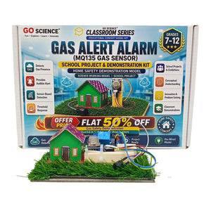 Go_Science_Classroom_Series_Gas_Alert_Alarm_MQ135_Gas_Sensor_School_Project_Demonstration_Kit_image with retail packing. A small electronic DIY project kit on a white background, featuring a green artificial grass base with a battery, two black wheels, a blue motor, a breadboard, and a yellow circuit board.