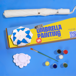 Umbrella painting kit with an umbrella, paint supplies, and packaging on a blue background. Kitsters DIY Umbrella Painting Kit available at Go Science product image 1