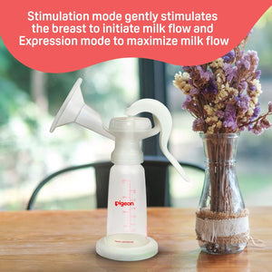 Pigeon breast pump on a table with a vase of flowers in the background. Pigeon Breast Pump Basic Edition go littles product image 5