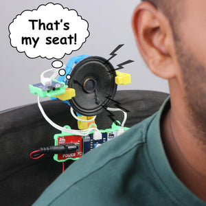 Person wearing a colorful homemade electronic device with a thought bubble saying 'That's my seat!' WitBlox DIY Talking Robot Build Talking Based Projects available at Go Science product image 7