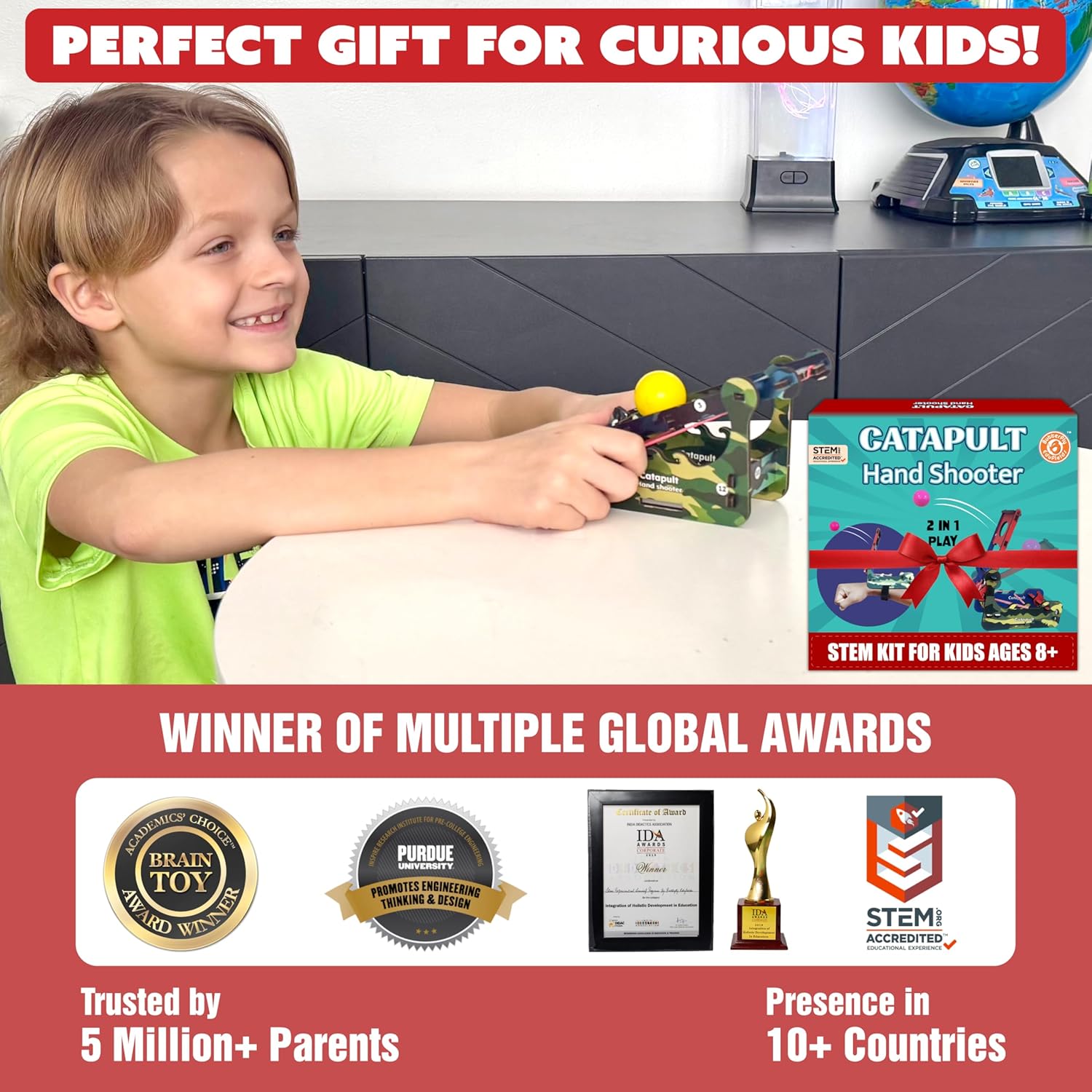 Child playing with a STEM kit, surrounded by educational toys and awards on a red background.  Butterfly EduFields DIY Catapult Shooter Science Kit_available at go science image 6