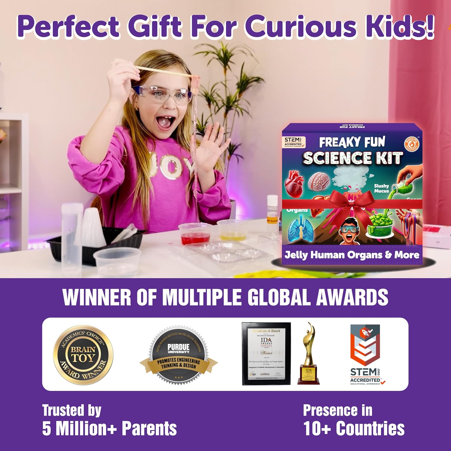 Girl with goggles next to a 'Freaky Fun Science Kit' box, with awards displayed below.