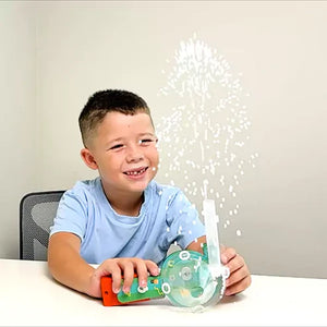 Child playing with a toy that creates a bubble effect, smiling at the camera. Butterfly edufields_4_in_1_Motor_Play_at_Go_Science_Product_image_8