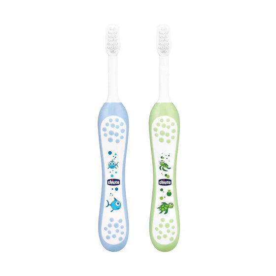 Two children's toothbrushes, one blue and one green, with cartoon designs on a white background. Chicco Toothbrush Set 6M to 36M Blue & Green Pack of 2 go littles