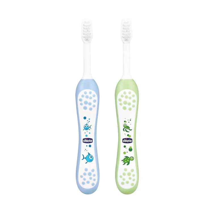 Two children's toothbrushes, one blue and one green, with cartoon designs on a white background. Chicco Toothbrush Set 6M to 36M Blue & Green Pack of 2 go littles