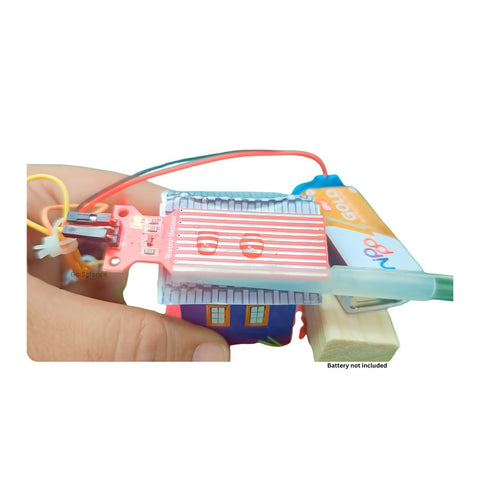 A hand holding a small electronic circuit board kit with colorful wires, a small house-shaped component, and a battery pack, shown against a plain white background. GO Science Classroom Series Rainwater Harvesting Model & Rain Alarm school project kit image 2