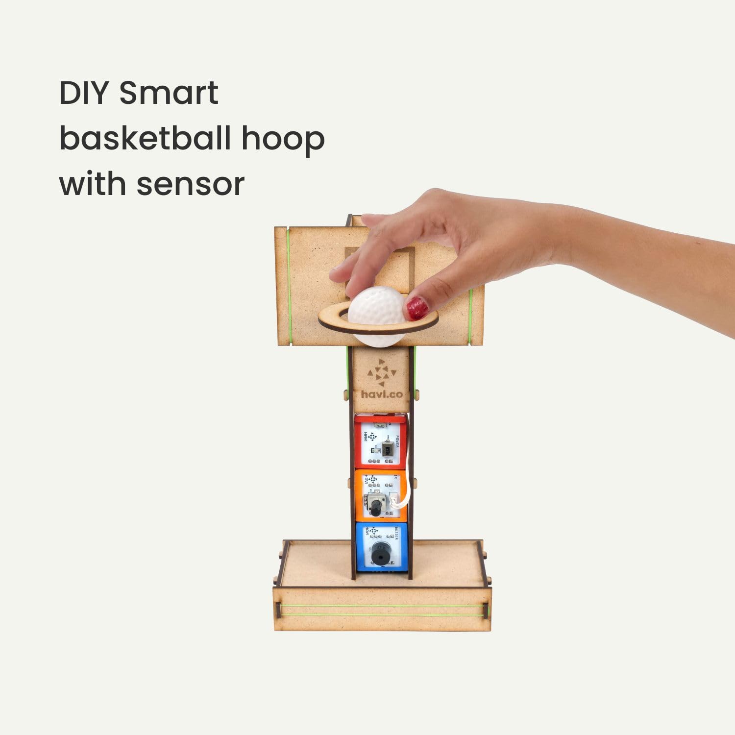 Hand holding a small ball near a DIY smart basketball hoop with sensor on a white background. Havi 12 in 1 DIY School Sensor Projects kit product image 3 at go science
