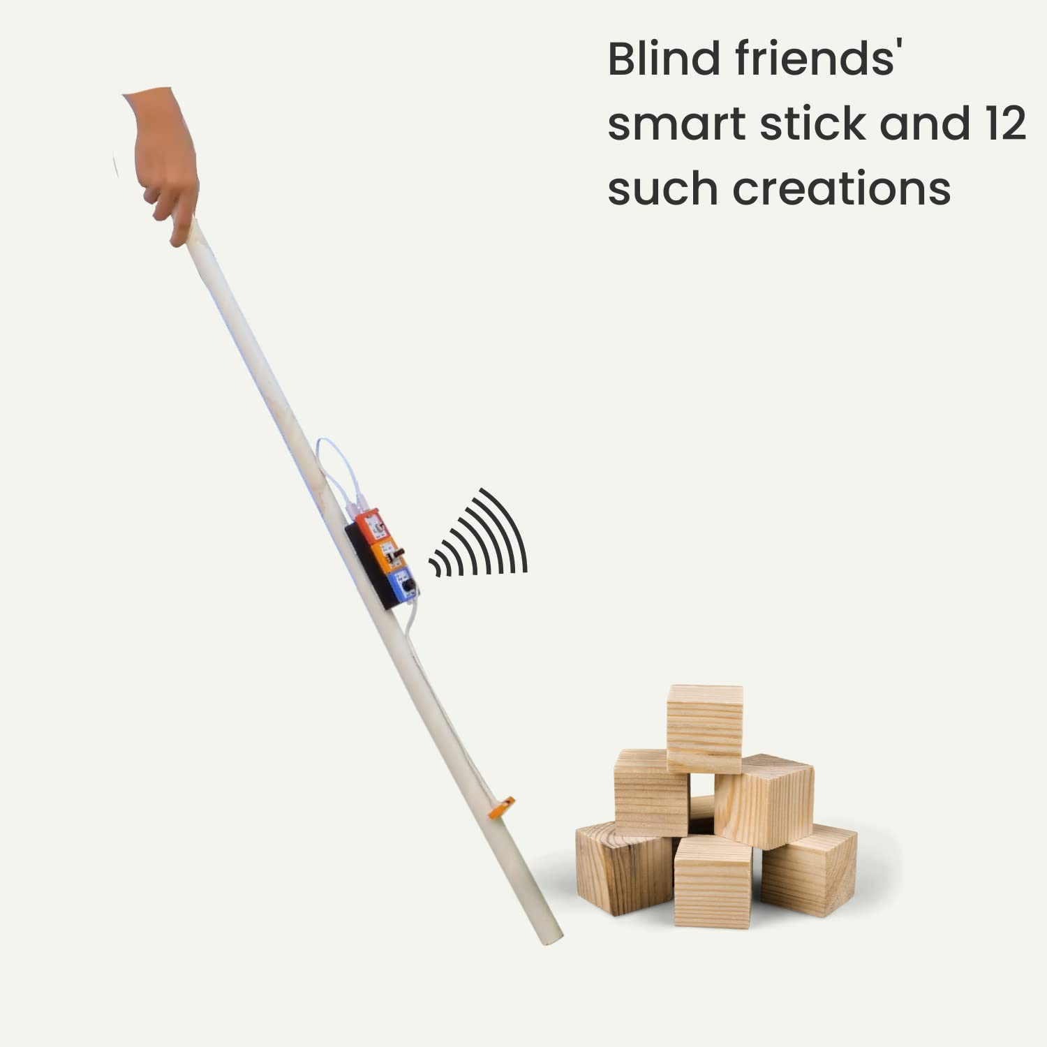 Smart stick for blind people with a hand holding it, next to wooden blocks on a white background. Havi 12 in 1 DIY School Sensor Projects kit product image 6 at go science