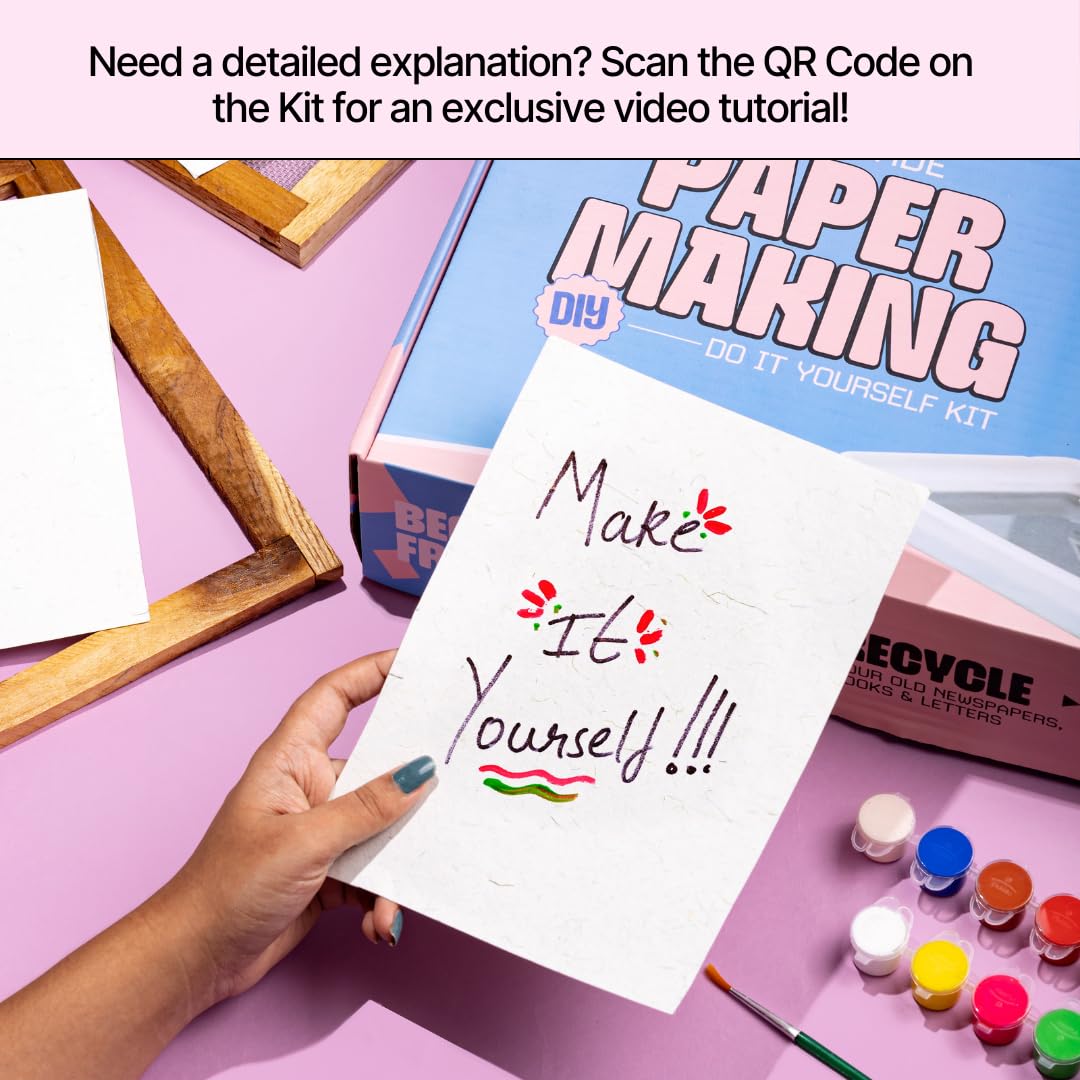 Hand holding a piece of paper with 'Make It Yourself!' text, next to a paper making kit on a pink surface. Kitsters DIY Handmade Paper Kit at Go Science Product Image 6