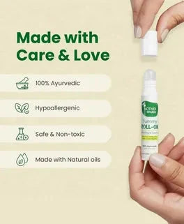 Hand holding a bottle of Ayurvedic roll-on with product details on a light green background. Mother Sparsh Tummy Roll-On Hing & Sounf Oil, 6 ml go littles product main branch 4