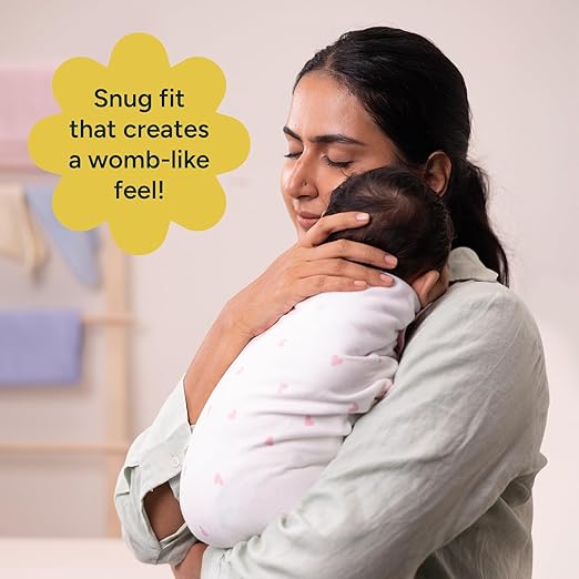 Mother holding a baby in a white wrap with text about a 'snug fit' feel.Nintara Wake Me Not Swaddle Pretty Petals for 0 to 3 Months go littles product image 5