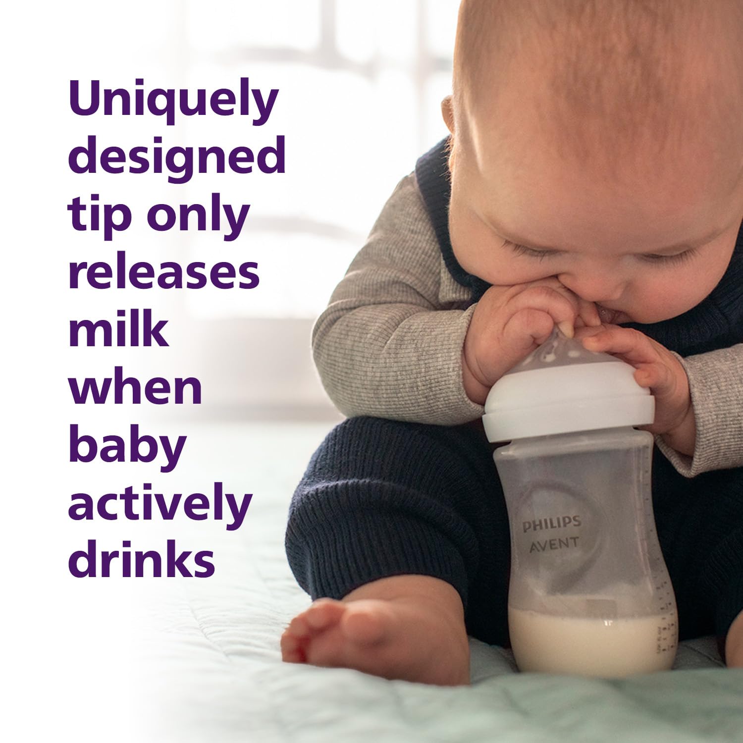 Baby drinking from a Philips Avent bottle with text about the bottle's unique design. Philips Avent Natural Response Baby Feeding Bottle 260ml_golittles_product_image 4