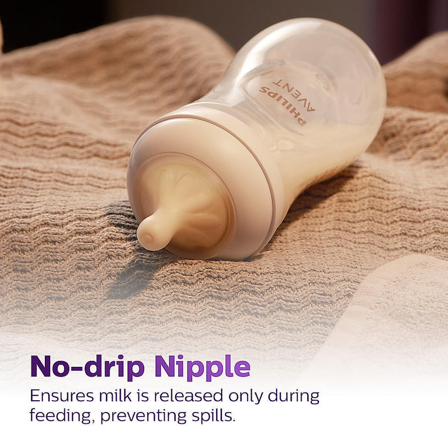 Baby bottle with no-drip nipple on a textured surface.Philips_Avent_Natural_Response_Teat_for_Babies_Aged_6_months_and_above_Flow_5_Pack_of_2_BPA_Free_SCY965_02_go_littles_product_image_5