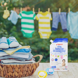 Baby clothes on a clothesline with Pigeon laundry detergent and baby items on a table. Pigeon Baby Laundry Detergent Liquid Refill 500 ml go littles product image 5
