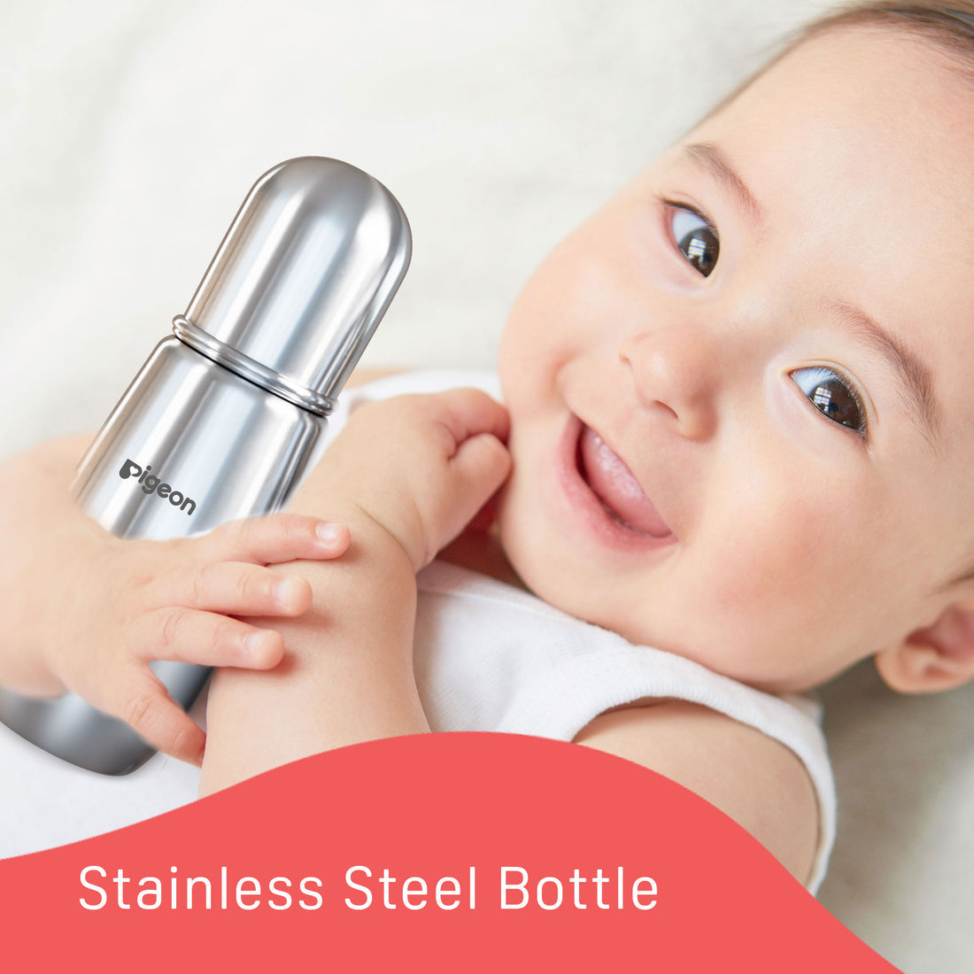 Baby holding a stainless steel bottle with a visible brand name, set against a white background. Pigeon Steel Feeding Bottle 220ml L Size 9months+_go littles_product image 5
