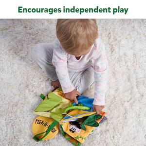Child playing with colorful toys on a carpeted floor, with text 'Encourages independent play' at the top. Skillmatics Peek A Boo i see you In the Jungle Soft Cloth Book at Go Littles product image 4