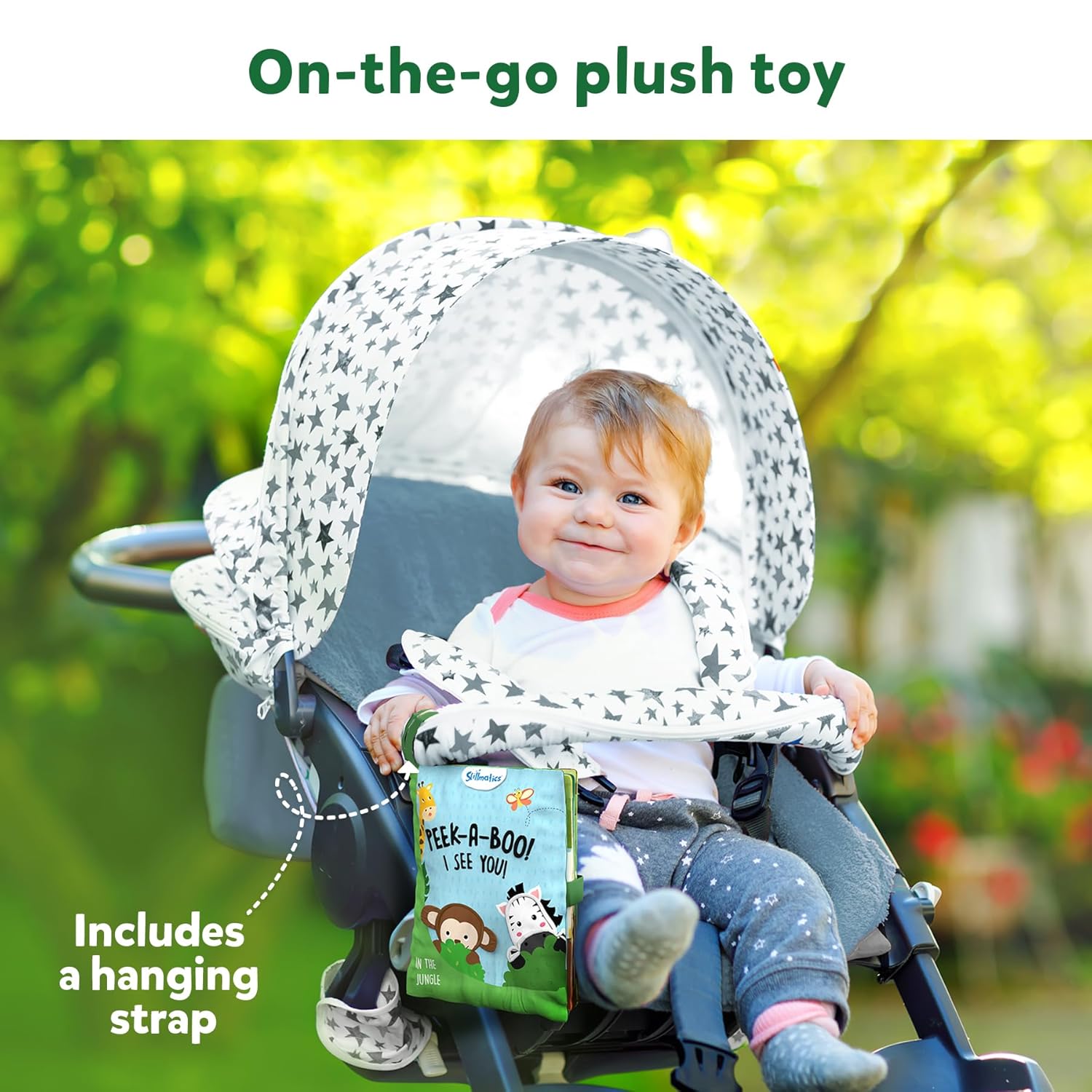 Skillmatics Peek A Boo i see you In the Jungle Soft Cloth Book at Go Littles product image 5. Child in a stroller with a plush toy and book, outdoors.