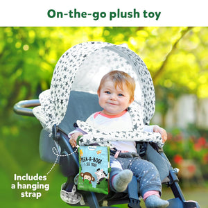 Skillmatics Peek A Boo i see you In the Jungle Soft Cloth Book at Go Littles product image 5. Child in a stroller with a plush toy and book, outdoors.