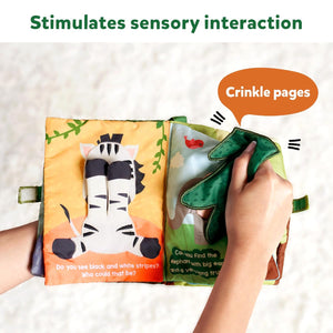 Skillmatics Peek A Boo i see you In the Jungle Soft Cloth Book at Go Littles product image 6. Children's book with crinkle pages held by a hand, on a soft surface.