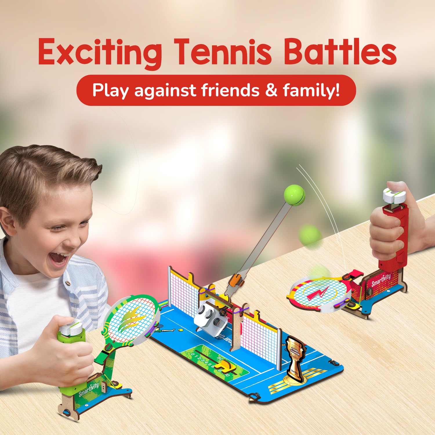 Children playing with a toy tennis set on a table, with text 'Exciting Tennis Battles' and 'Play against friends & family!'. Smartivity Mini Tennis at Go Science product image 