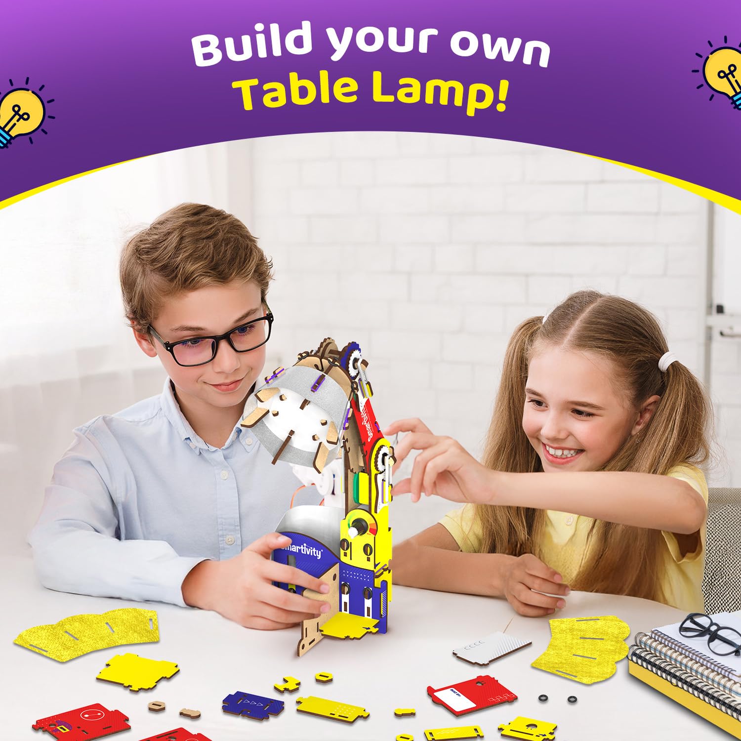Two children building a table lamp from colorful parts on a white table. Smartivity Table Lamp available at Go Science Product image 2