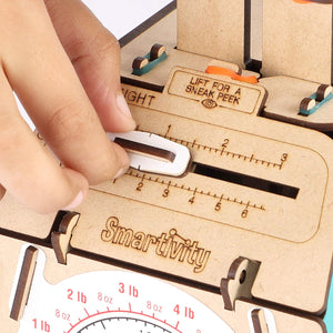 Wooden measuring tool with a hand lifting a cover, branded 'Smartivity'. Smartivity Weighing Machine available at Go Science Product Image 6