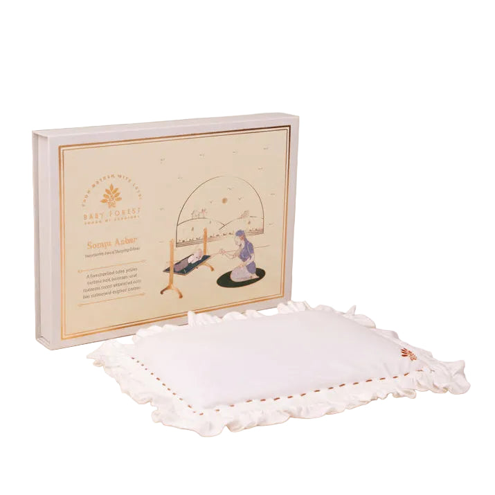White 
Somya Aakar Newborn’s Head-Shaping Mustard Pillow
 embroidered pillow with a decorative box on a beige background