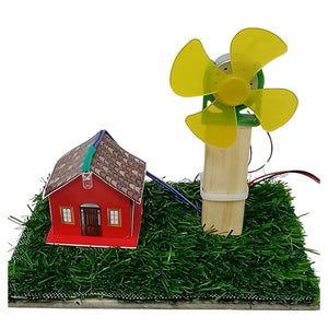 Go Science classroom series A small wind-powered house model on a white background of windmill project. The scene includes a red house with a brown roof, green artificial grass, a wooden post, and a yellow fan attached to a motor with wires.